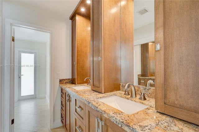 bathroom with tile patterned floors and vanity