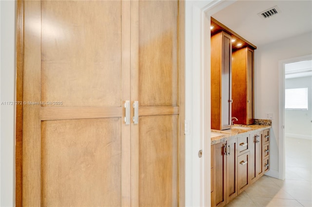 interior space featuring sink and light tile patterned floors