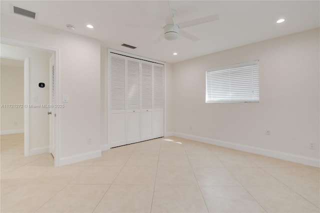 unfurnished bedroom featuring light tile patterned floors, a closet, and ceiling fan