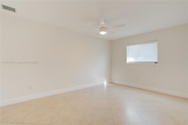 unfurnished room with light tile patterned floors and ceiling fan