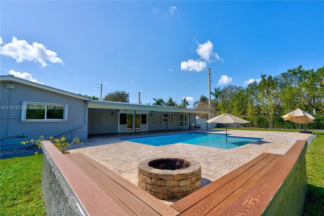 view of pool with a patio and a fire pit