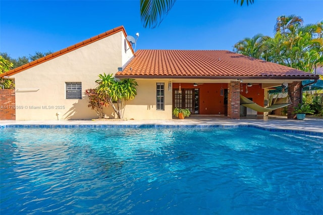 view of pool with ceiling fan, a patio area, and french doors