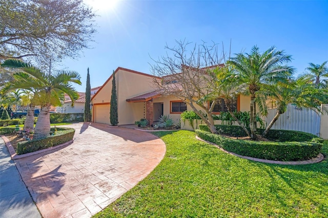 view of front of home with a front yard and a garage