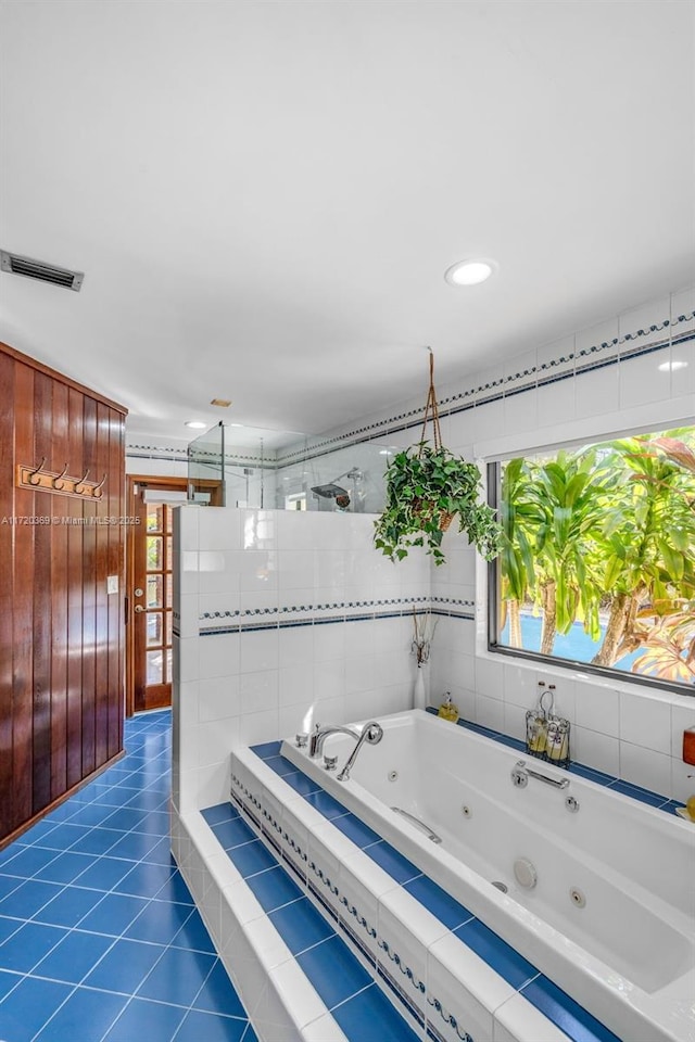 bathroom featuring shower with separate bathtub, tile patterned floors, and plenty of natural light