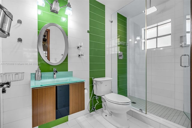 bathroom with tile patterned floors, vanity, toilet, and an enclosed shower