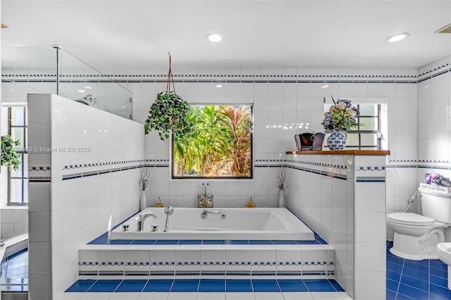 bathroom featuring tile patterned floors, a shower, a bidet, tile walls, and toilet