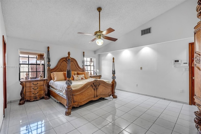 tiled bedroom with a textured ceiling, ceiling fan, multiple windows, and vaulted ceiling