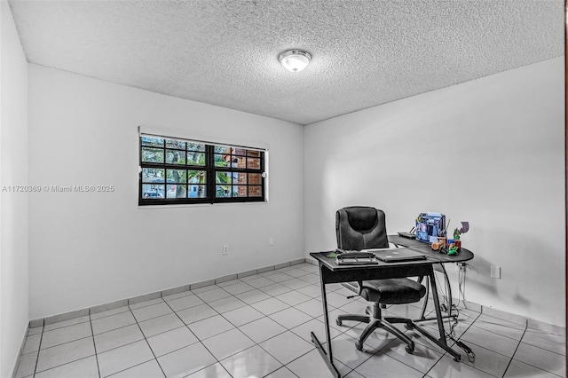 tiled home office featuring a textured ceiling