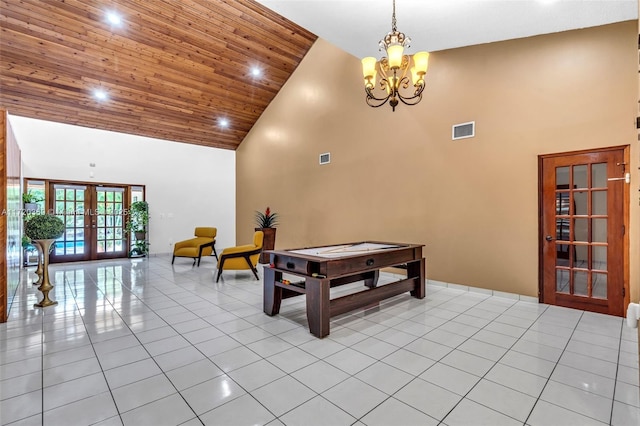 recreation room featuring french doors, wood ceiling, light tile patterned floors, high vaulted ceiling, and an inviting chandelier