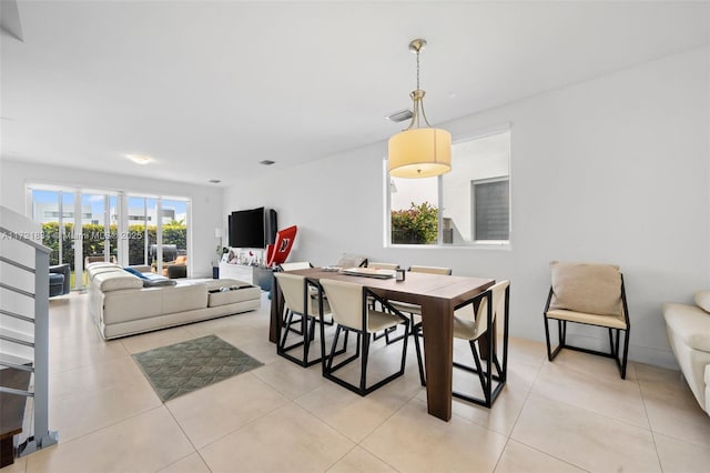 dining space featuring light tile patterned floors