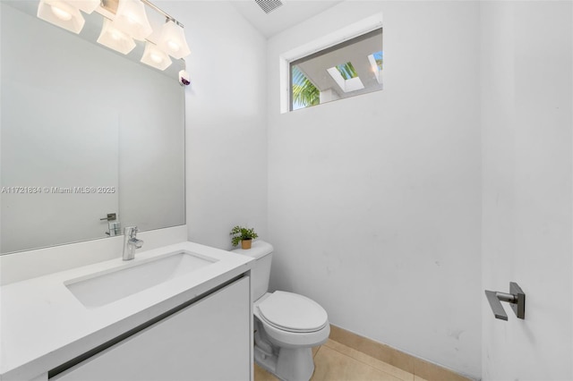 bathroom with tile patterned floors, vanity, and toilet