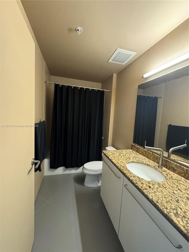 full bathroom with tile patterned flooring, vanity, shower / bath combo, and toilet