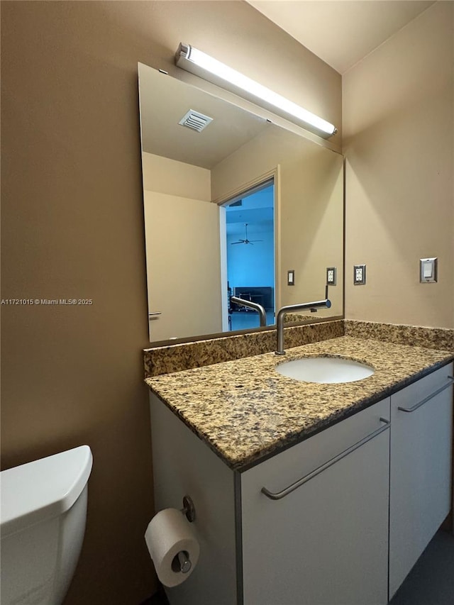 bathroom featuring vanity and toilet