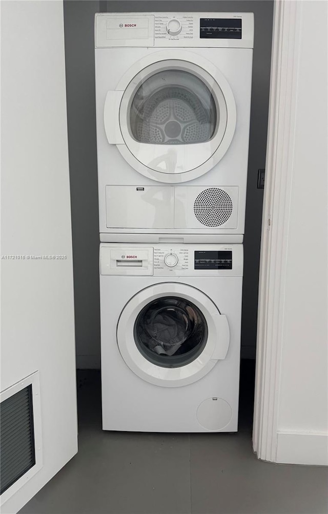 washroom with stacked washer and clothes dryer