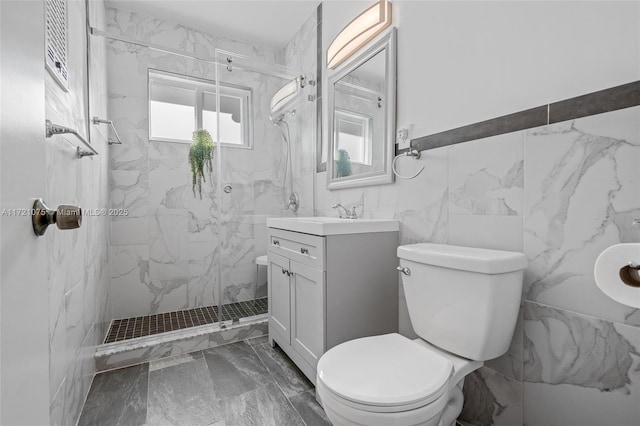 bathroom featuring vanity, toilet, and a tile shower