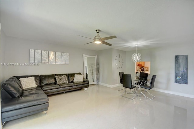 living room featuring ceiling fan with notable chandelier