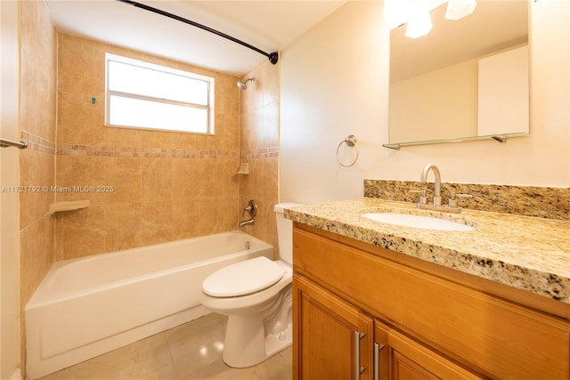 full bathroom featuring tile patterned floors, tiled shower / bath combo, toilet, and vanity