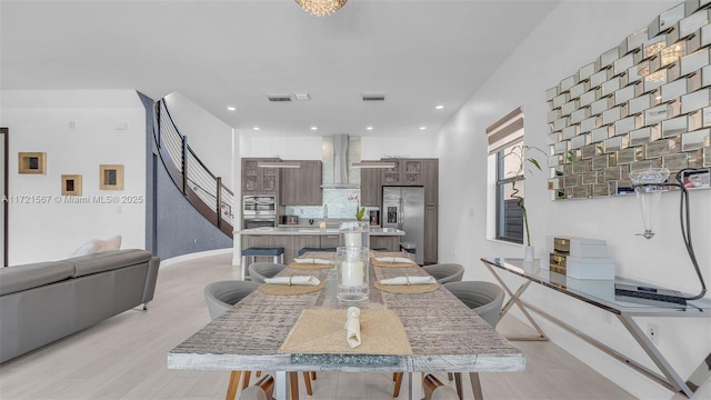 dining room with light hardwood / wood-style floors and sink