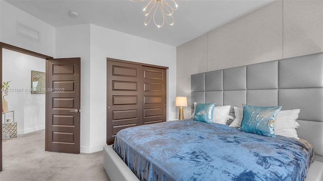 bedroom with light colored carpet and an inviting chandelier