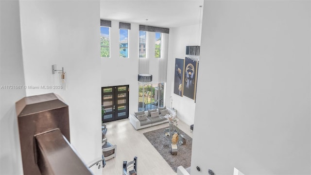 living room with french doors and wood-type flooring