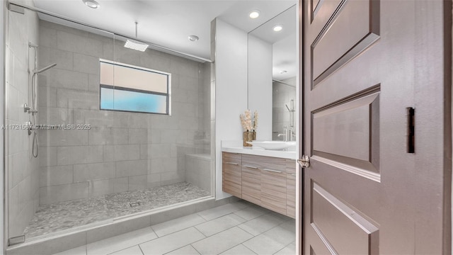 bathroom featuring tile patterned floors, vanity, and tiled shower