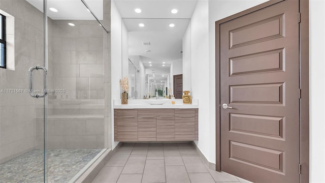 bathroom with tile patterned floors, vanity, and a shower with shower door