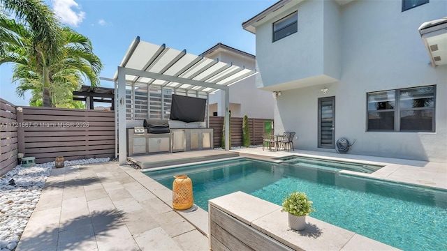 view of swimming pool with a pergola, exterior kitchen, and a patio