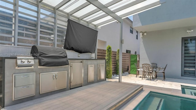 view of patio / terrace featuring an outdoor kitchen, a pergola, a swimming pool side deck, and grilling area