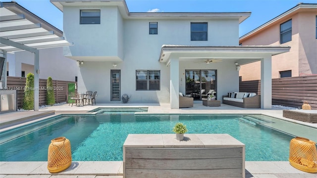 back of house with outdoor lounge area, ceiling fan, a patio area, and a pool with hot tub