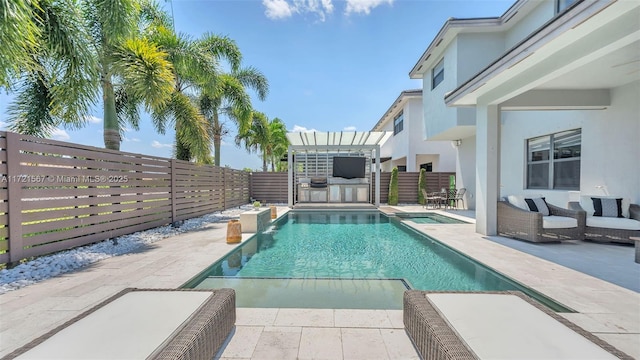 view of swimming pool with exterior kitchen, a patio, and a hot tub