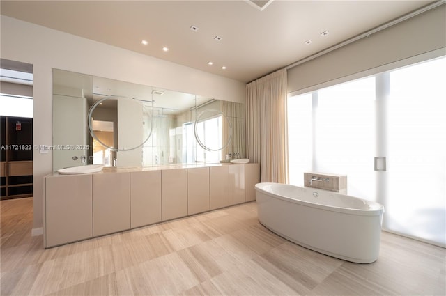 bathroom featuring vanity and a bath