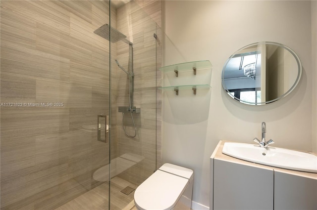 bathroom with vanity, toilet, and a shower with shower door