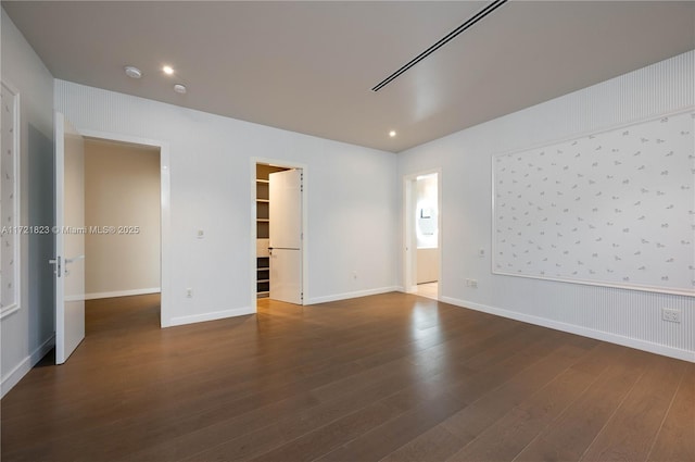 empty room with dark hardwood / wood-style flooring