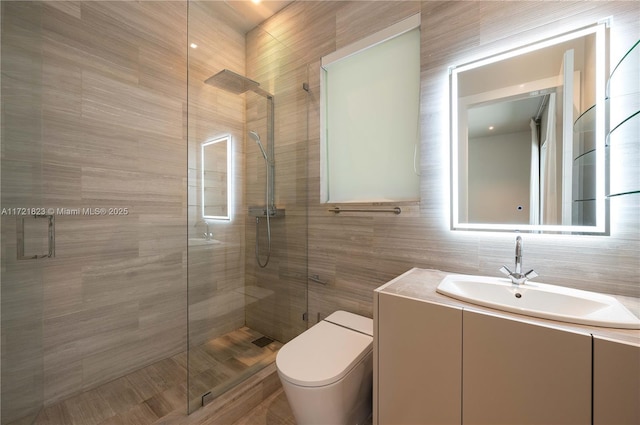 bathroom with walk in shower, vanity, and toilet