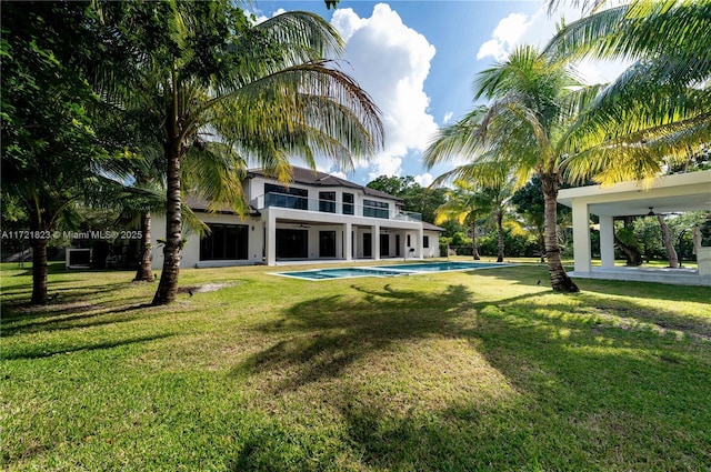 rear view of property with a yard