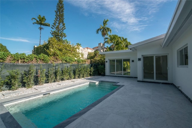 view of pool featuring a fenced in pool, a patio, and fence