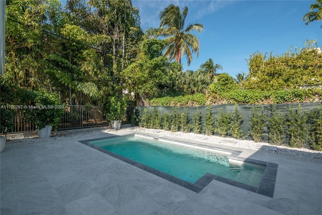 view of pool with a patio area, a fenced backyard, and a fenced in pool