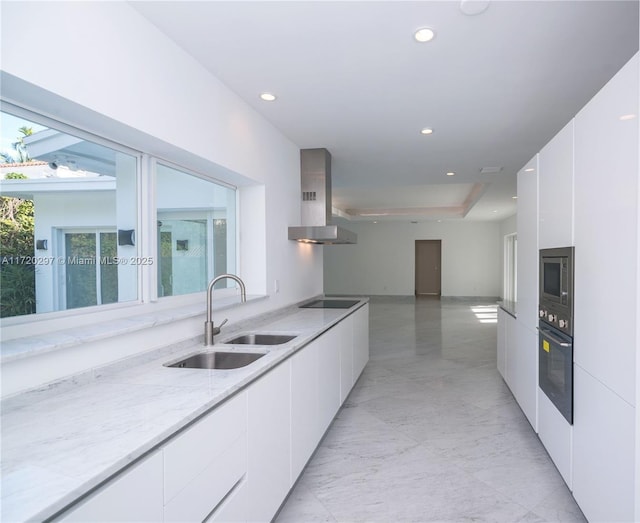 kitchen with a sink, white cabinetry, wall chimney exhaust hood, black appliances, and modern cabinets