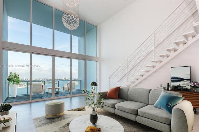 living room featuring a water view and an inviting chandelier