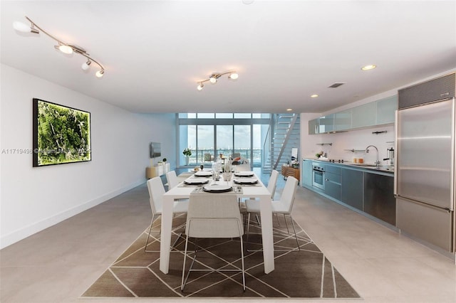 dining room with floor to ceiling windows and sink