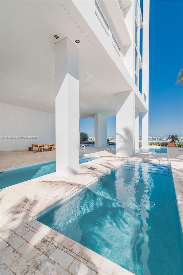 view of pool featuring a patio area