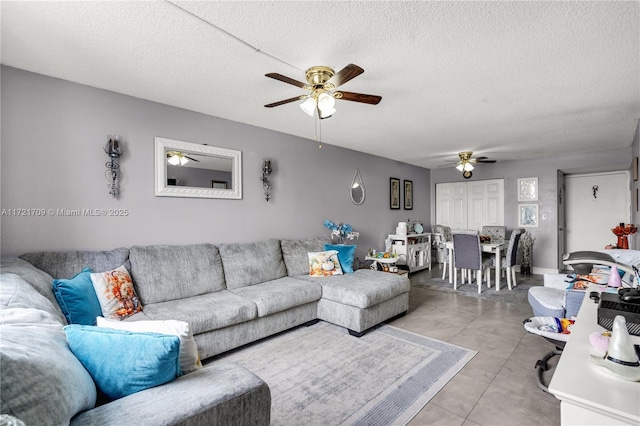 living room with light tile patterned flooring and a textured ceiling