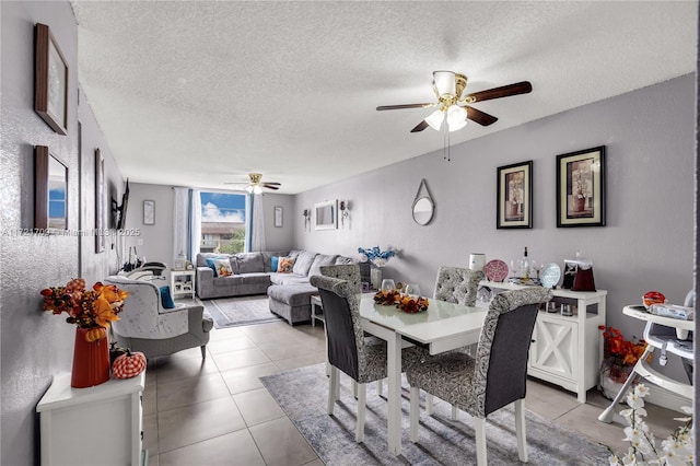 dining room featuring light tile patterned floors, a textured ceiling, and ceiling fan