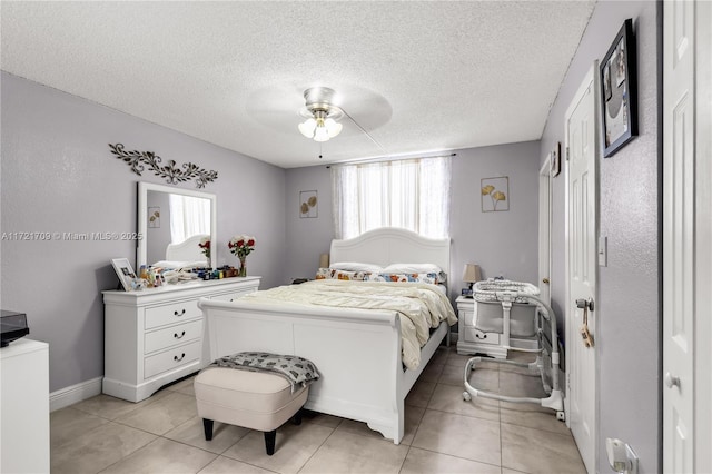 tiled bedroom featuring ceiling fan and a textured ceiling