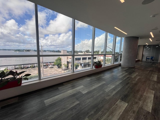 unfurnished room featuring a water view