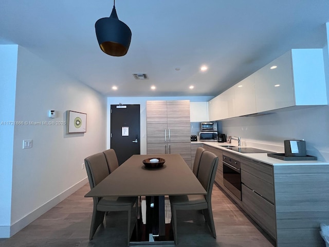 kitchen featuring white cabinetry, a breakfast bar, a kitchen island, and stainless steel appliances