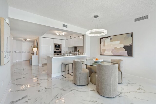 living room featuring expansive windows and a textured ceiling