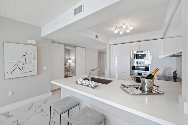 living room with a textured ceiling and a chandelier