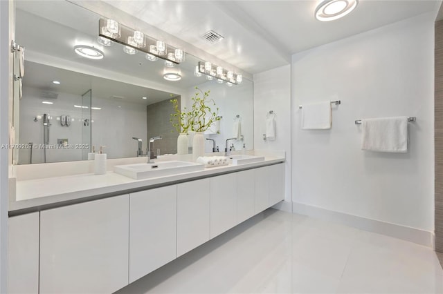 bathroom with double vanity, baseboards, visible vents, and a sink