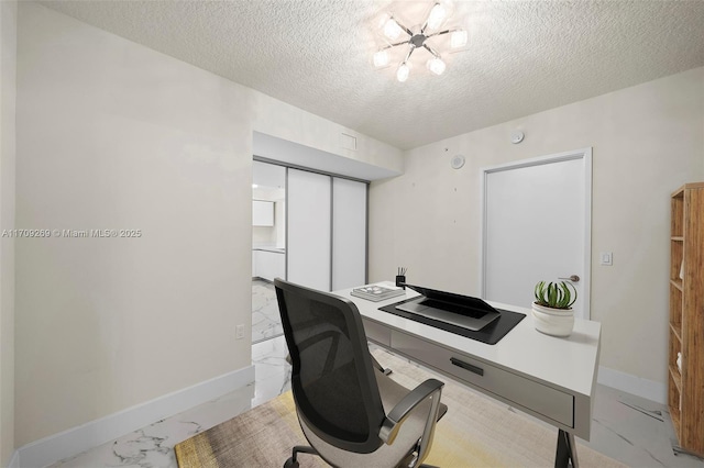 office area featuring a textured ceiling and a chandelier